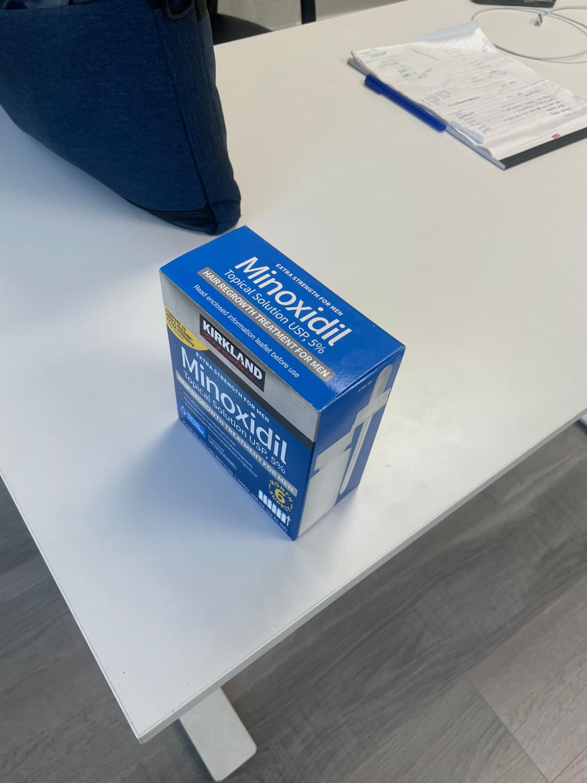 Minoxidil box on a white surface with a blurred background
